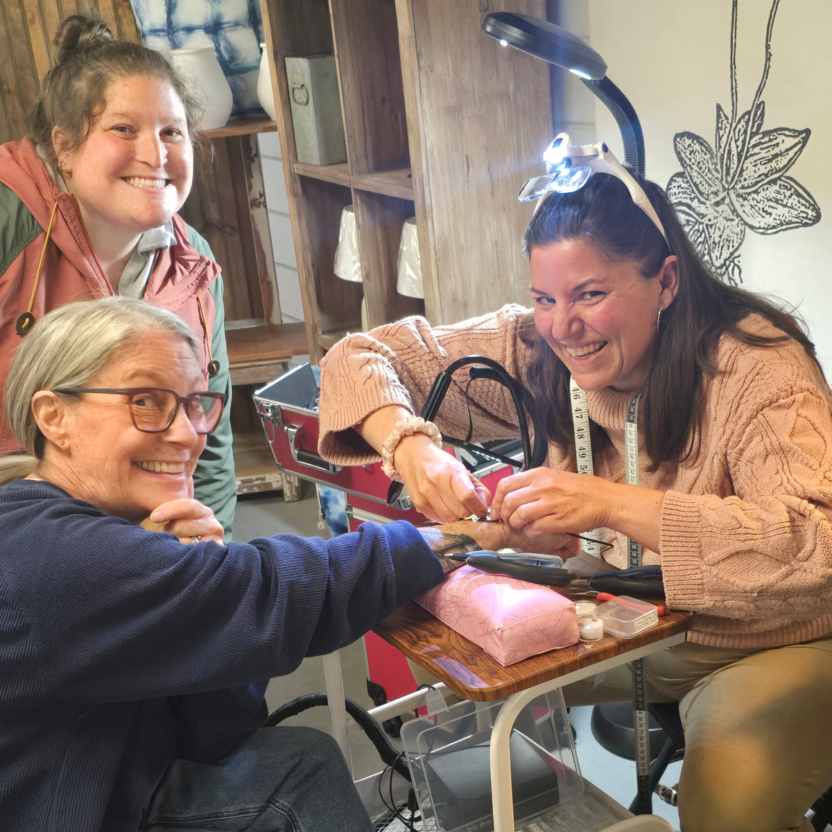 “Women enjoying a permanent jewelry girls’ night party in Windham Maine with custom welded bracelets and anklets.”