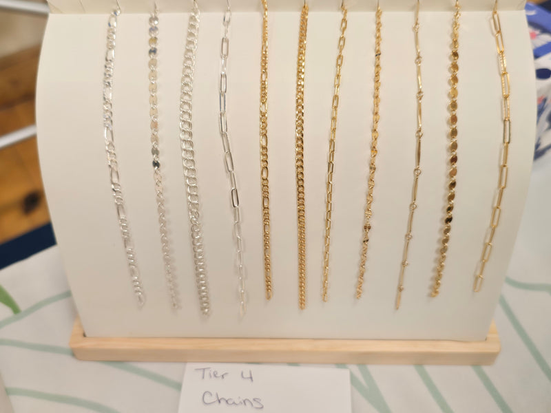 “Gem Lounge Jewelry permanent jewelry setup with chain samples and charms for private events in Windham and Portland Maine.”