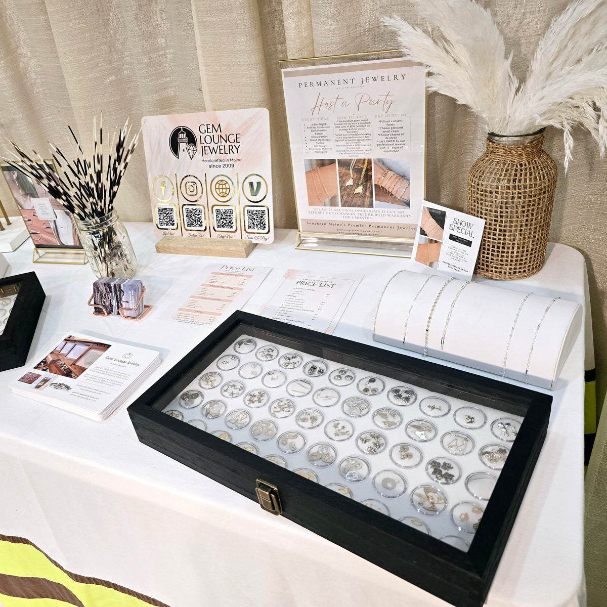 “Permanent jewelry event table setup with chain menu and welding tools for private bracelet parties in Windham and Southern Maine.”